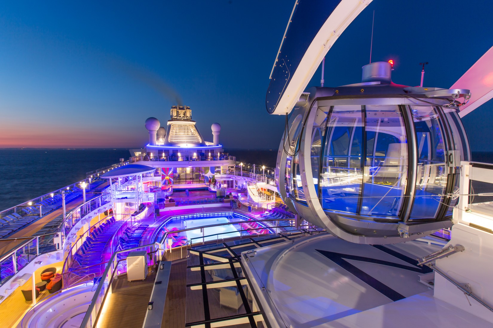 Royal Caribbean introduces its newest and most technologically advanced  cruise ship Anthem of the Seas. Pool Deck at sunset